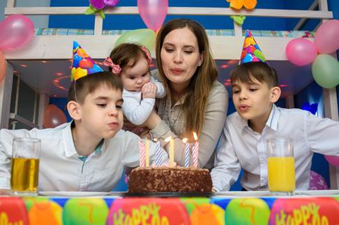 A family celebrating a birthday with a cake